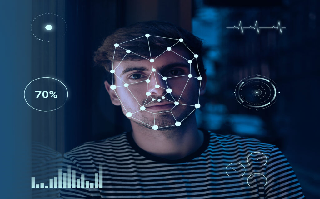 Young man with stubble staring at camera with computerised dots and lines outlining his face depicting facial recognition artificial intelligence software
