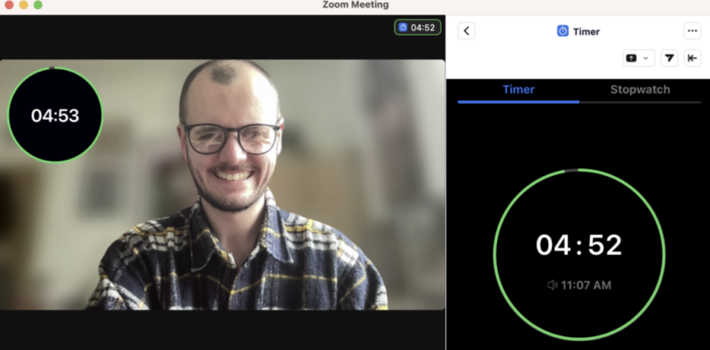 This is a screenshot of a Zoom video call with a five-minute timer present. 